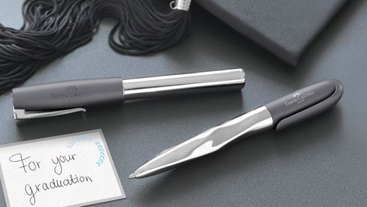 Fountain pen and ballpoint pen next to a card "for your graduation"